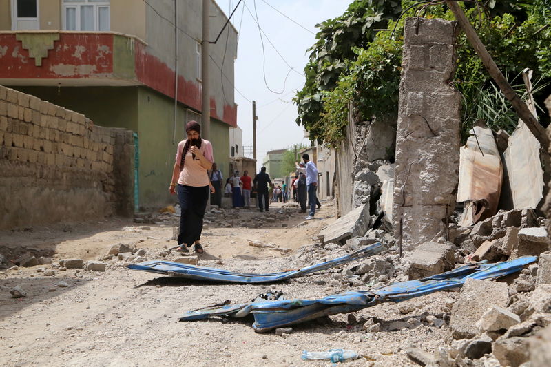 © Reuters. Woman walks along a street in the southeastern Turkish town of Silopi