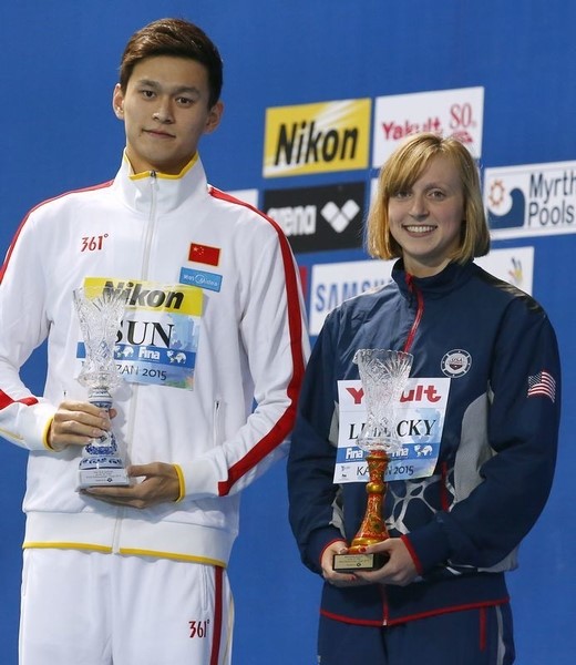 © Reuters. China's Sun and Ledecky of U.S. pose with their awards for best swimmers of championships at Aquatics World Championships in Kazan