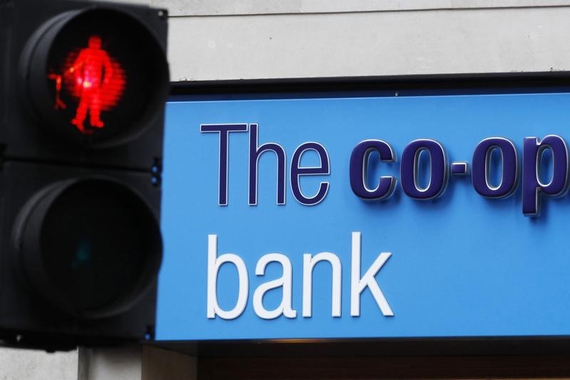 © Reuters. A red crossing light is pictured next to a branch of the Co-operative Bank in London