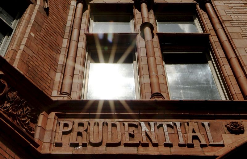 © Reuters. File photo of the sun reflecting in a window above the raised lettering of the former Prudential Assurance building in the City of London