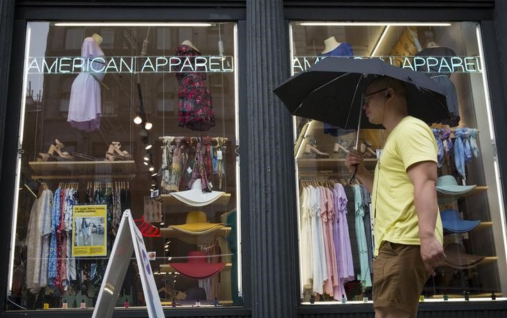 © Reuters. A man walks past an American Apparel store in New York