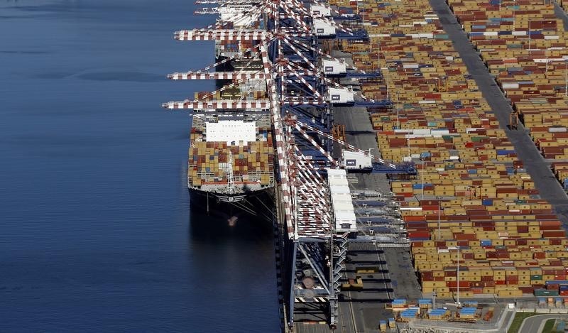 © Reuters. A container ship, cranes and containers are seen from a helicopter at Italy's biggest container port Gioia Tauro in the southern Italian region of Calabria