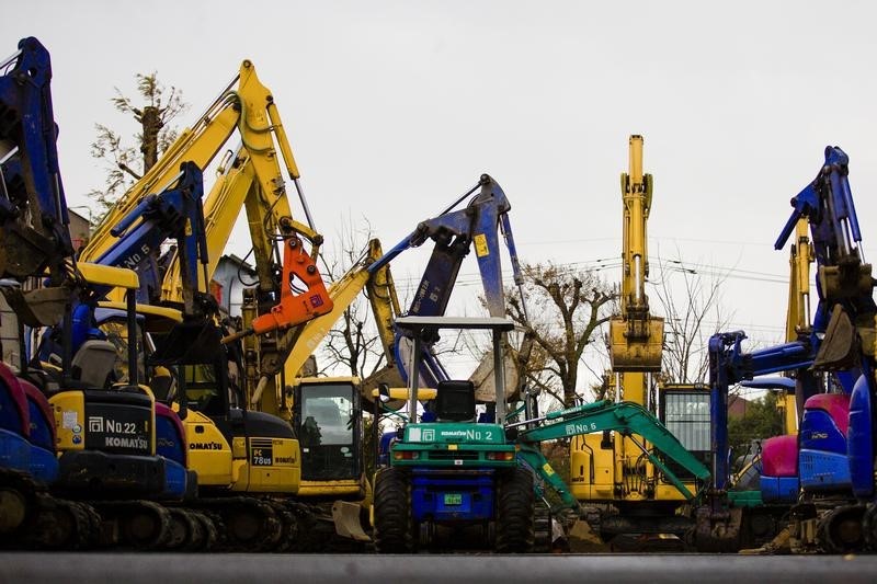 © Reuters. Excavators are parked in machine yard in Tokyo