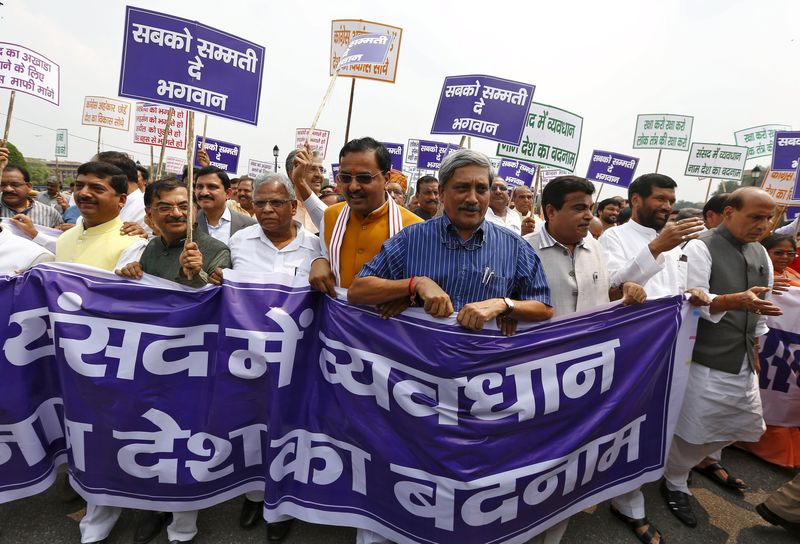 © Reuters. India's DM Parrikar along with lawmakers from India's ruling BJP and its allies, take part in what they say is a Save Democracy march in New Delhi