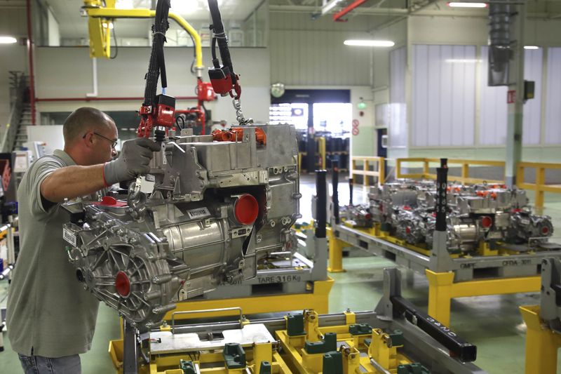 © Reuters. A employee handles the new R240 electric engine by French carmaker Renault for their Zoe model automobile at their factory in Cleon