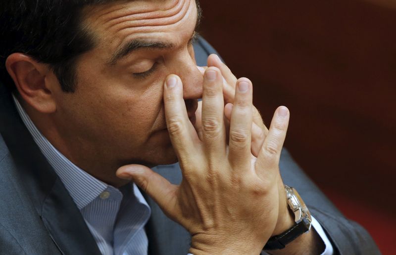 © Reuters. Greek Prime Minister Alexis Tsipras reacts as he attends the end of a night parliamentary session in Athens