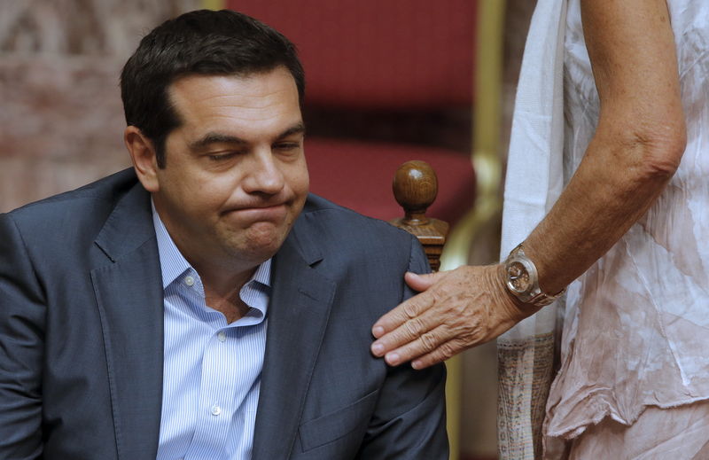 © Reuters. Greek Prime Minister Alexis Tsipras reacts as he attends a parliamentary session in Athens