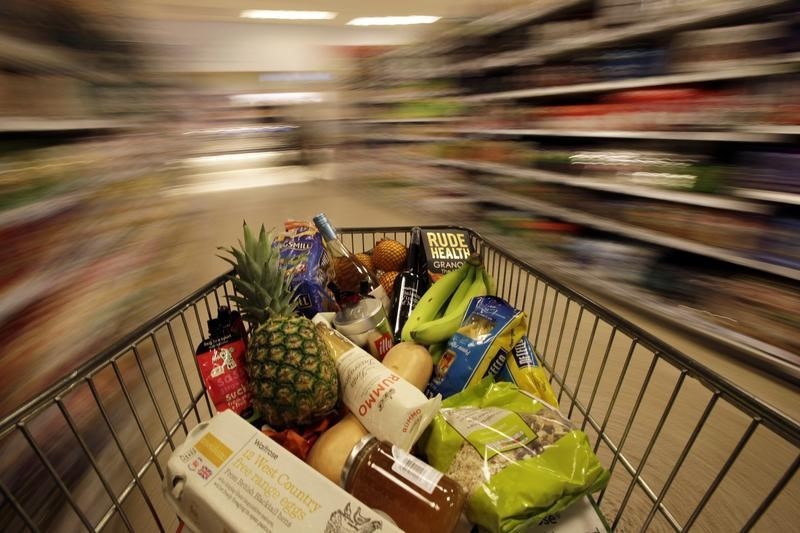 © Reuters. A shopping trolley is pushed around a supermarket in London