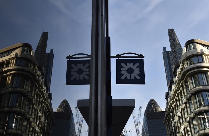 © Reuters. A logo at a branch of the Royal Bank of Scotland is seen reflected in a window in the City of London