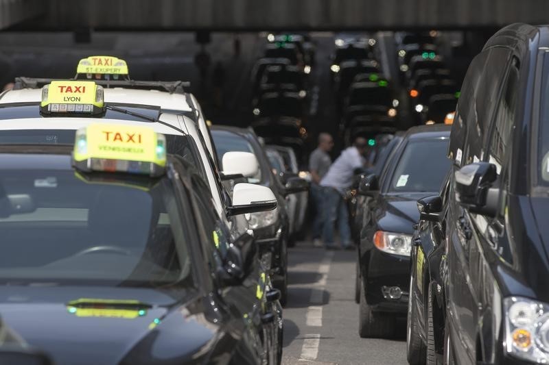 © Reuters. French taxi drivers block the access of the Lyon Part Dieu train station during a national protest against car-sharing service Uber, in Lyon