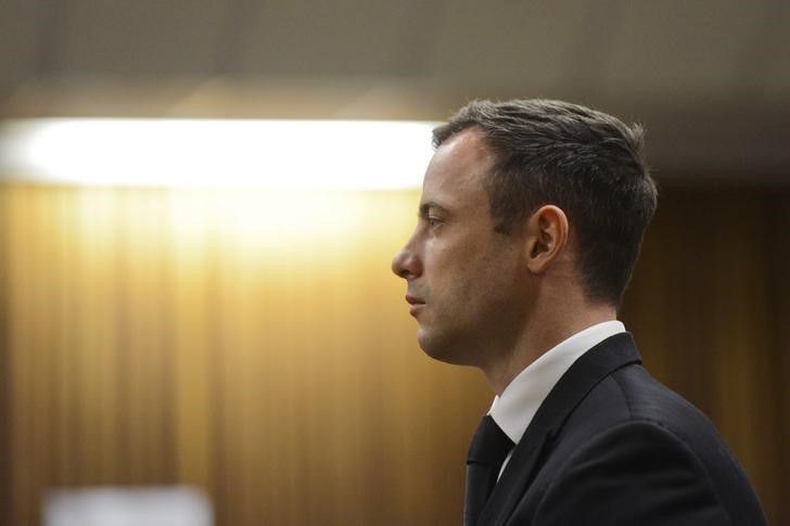 © Reuters. South African Olympic and Paralympic track star Pistorius stands in the dock as his sentence is delivered at the North Gauteng High Court in Pretoria