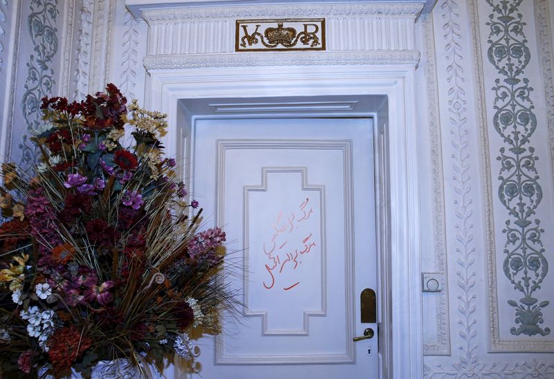 © Reuters. Graffiti in Persian reading "Death to England" is seen on door inside British Embassy in Tehran