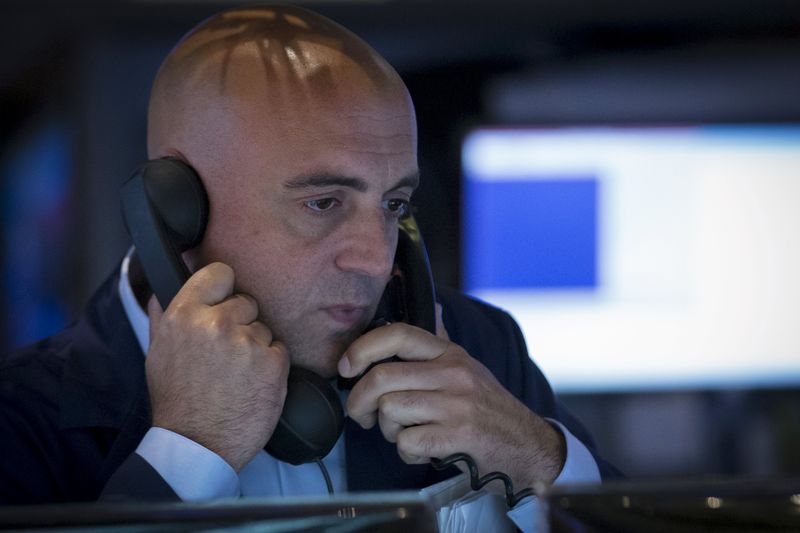 © Reuters. A trader works inside a booth on the floor of the New York Stock Exchange 