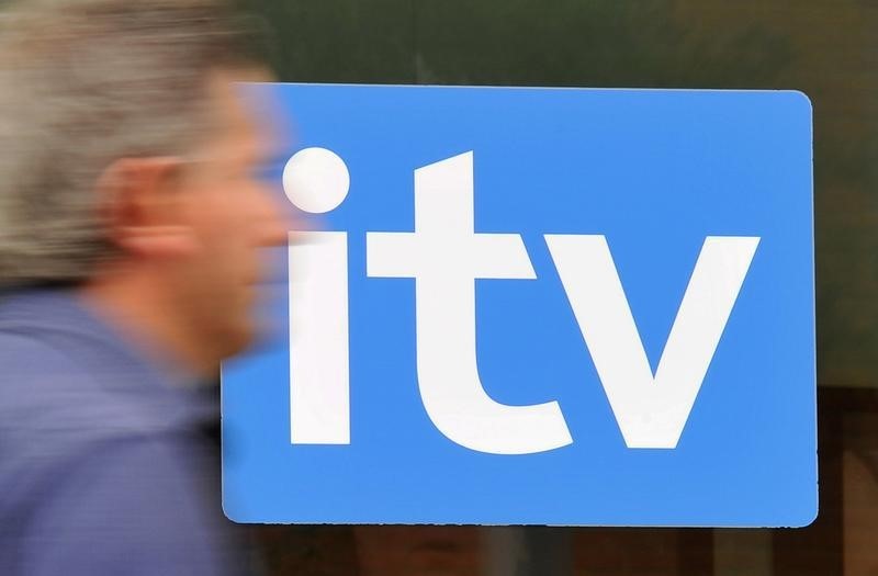 © Reuters. A man passes ITV television studios in London