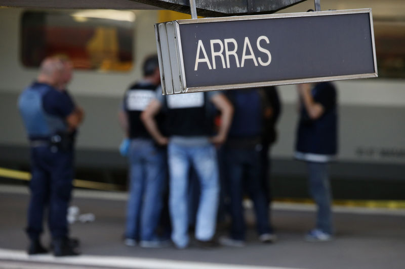 © Reuters. French judicial police stand on the platform next to the Thalys high-speed train where shots were fired in Arras