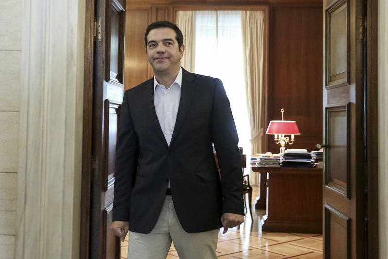 © Reuters. Greek PM Tsipras stands at his office door inside the Maximos Mansion in Athens