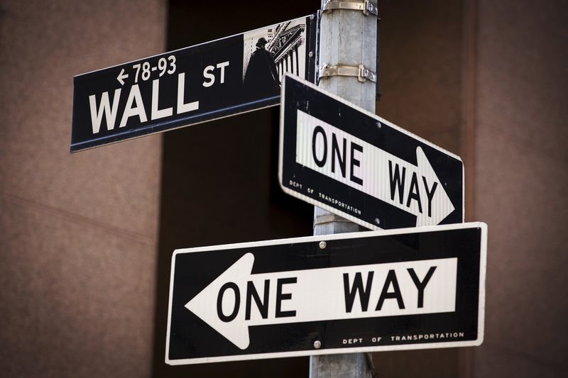 © Reuters. A 'Wall St' sign is seen above two 'One Way' signs in New York 