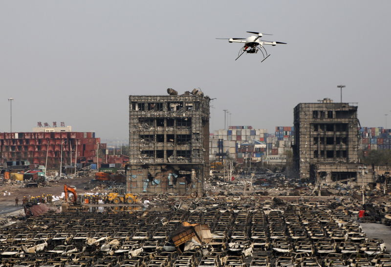 © Reuters. Drone operated by paramilitary police flies over the site of last week's explosions at Binhai new district in Tianjin, China