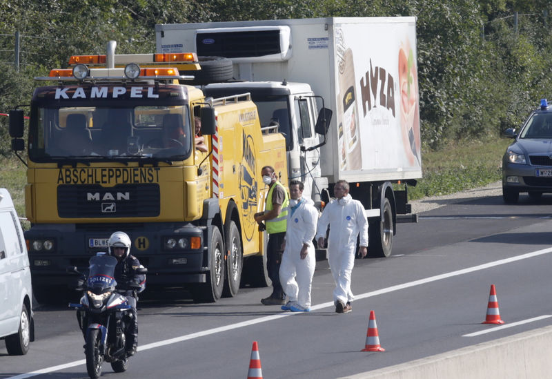 © Reuters. Truck in which up to 50 migrants were found dead is prepared to be towed away on a motorway near Parndorf