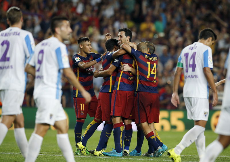 © Reuters. Barcelona's players celebrate a goal against Malaga during their Spanish first division soccer match at Camp Nou stadium in Barcelona