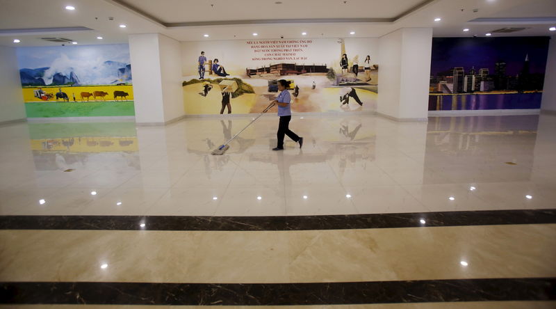 © Reuters. A woman cleans the floor of a V+ supermarket in Hanoi, Vietnam