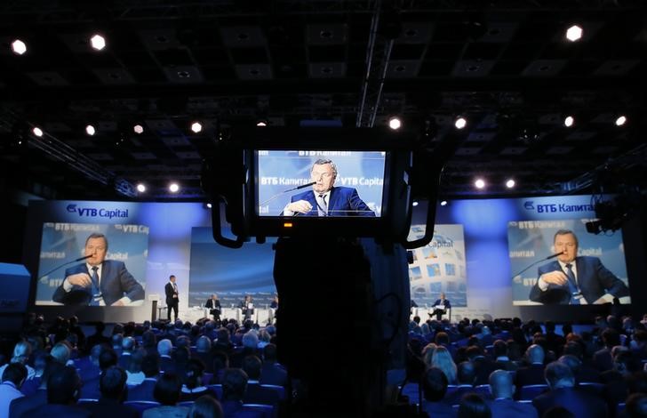© Reuters. Oleg Budargin, director-general of JSC "Russian Grids", is seen on screens as he speaks during the VTB Capital "Russia Calling!" Investment Forum in Moscow
