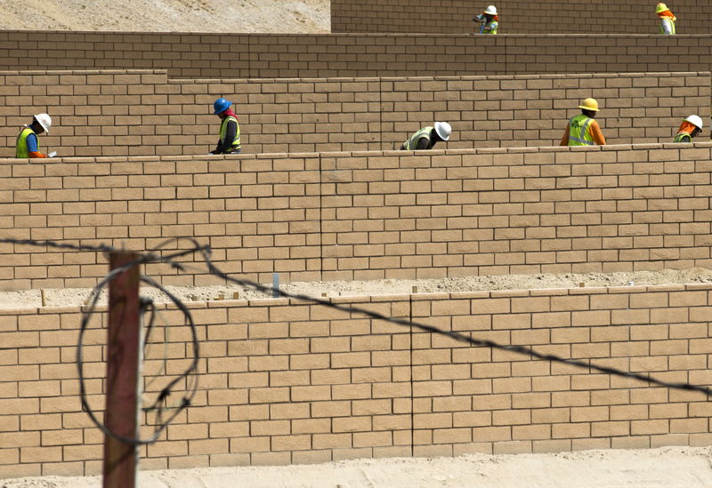 © Reuters. Workers are pictured at the construction site of a new residential home in San Diego, California