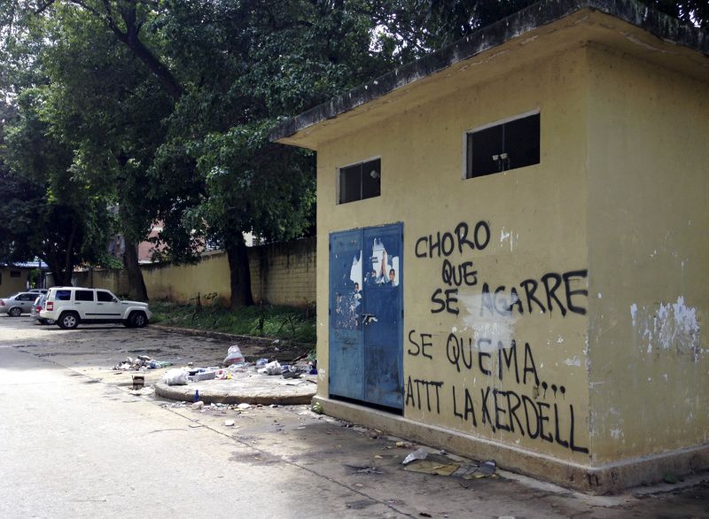 © Reuters. A graffiti that reads "Get ready, thief, here we burn you. Regards, Kerdell" is seen at a residential block in Valencia