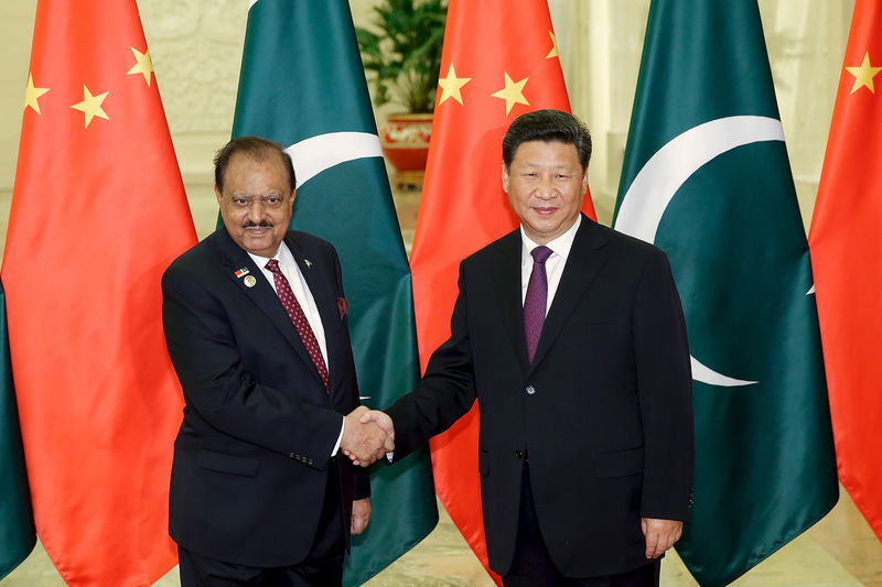 © Reuters. Xi shakes hands with Hussain at The Great Hall Of The People in Beijing