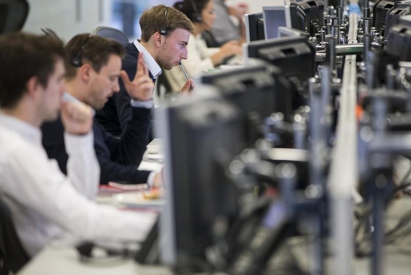 © Reuters. Dealers work on the IG Group trading floor in London, Britain