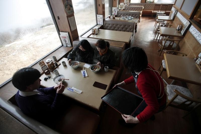 © Reuters. Customers sit at KiriKiri Zembei restaurant in KiriKiri town