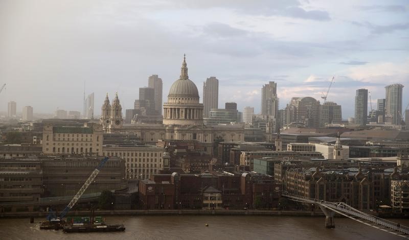 © Reuters. A rain cloud approaches St Paul's Cathedral in central London