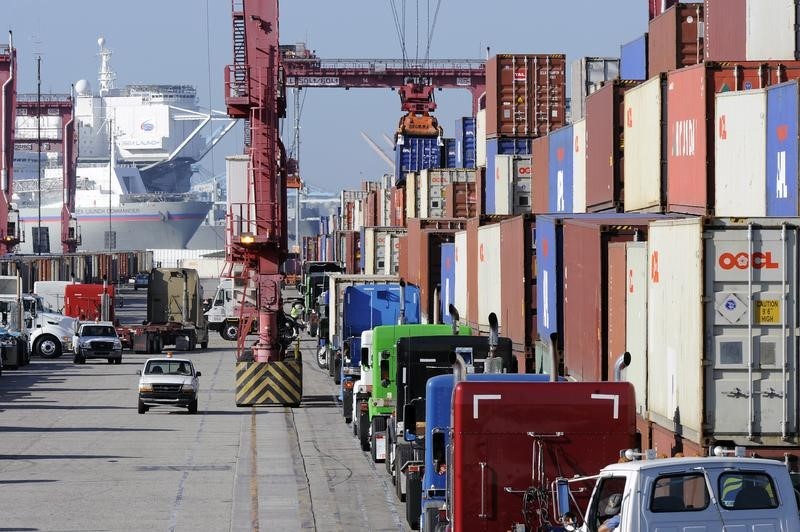 © Reuters. Semi trucks line up to pick up shipping containers at the Port of Long Beach