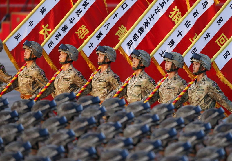 © Reuters. Soldiers of the Peoples Liberation Army (PLA) of China stand in formation as they gather ahead of a military parade to mark the 70th anniversary of the end of World War Two, in Beijing