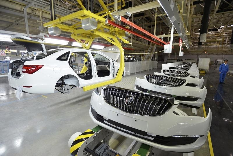 © Reuters. An employee looks on next to an assembly production line of Buick cars at a General Motors factory in Wuhan