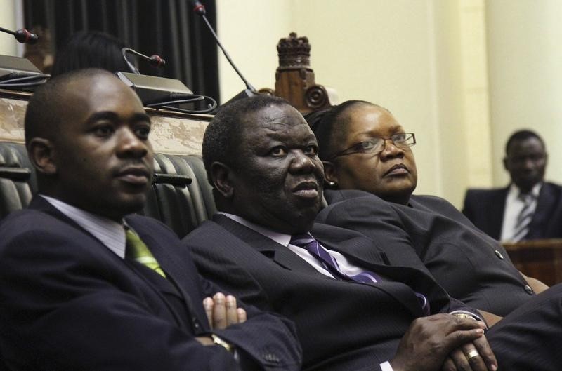 © Reuters. Zimbabwe Vice President Mujuru, PM Tsvangirai and member of the House of Assembly of Zimbabwe for Kuwadzana Nelson Chamisa attends the presentation of Final Draft of the Constitution for debate in Parliament Building in Harare