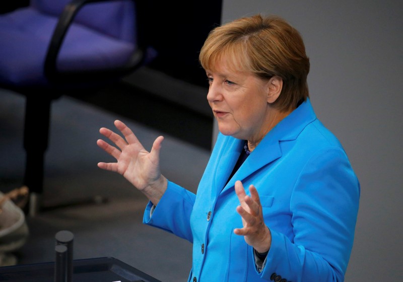 © Reuters. German Chancellor Merkel gestures as she addresses the lower house of parliament Bundestag on Germany's 2016 budget in Berlin