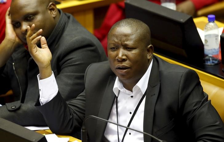 © Reuters. Malema reacts in parliament in Cape Town