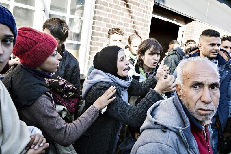 © Reuters. Group of migrants is seen at Padborg Station, Denmark