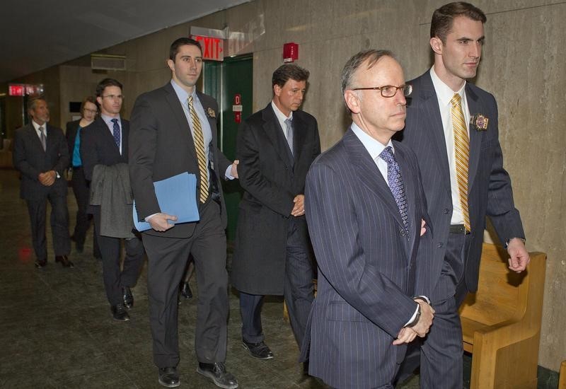 © Reuters. Law firm Dewey and Leboeuf's Davis, Sanders, DiCarmine and Warren arrive in handcuffs to Manhattan Criminal Court in the borough Manhattan borough of New York