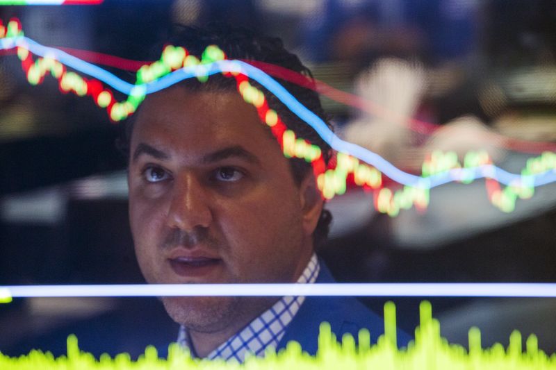 © Reuters. Trader works on the floor of the New York Stock Exchange shortly after the market opened in New York