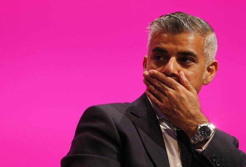 © Reuters. Shadow Justice minister Sadiq Khan, reacts as he listens to Yvette Cooper, Britain's opposition Labour Party's shadow home secretary speaks at the party's conference in Manchester