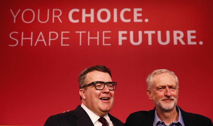 © Reuters. The new leader of Britain's opposition Labour Party Jeremy Corbyn waves next to newly elected deputy leader Tom Watson (L) after making his inaugural speech at the Queen Elizabeth Centre in central London
