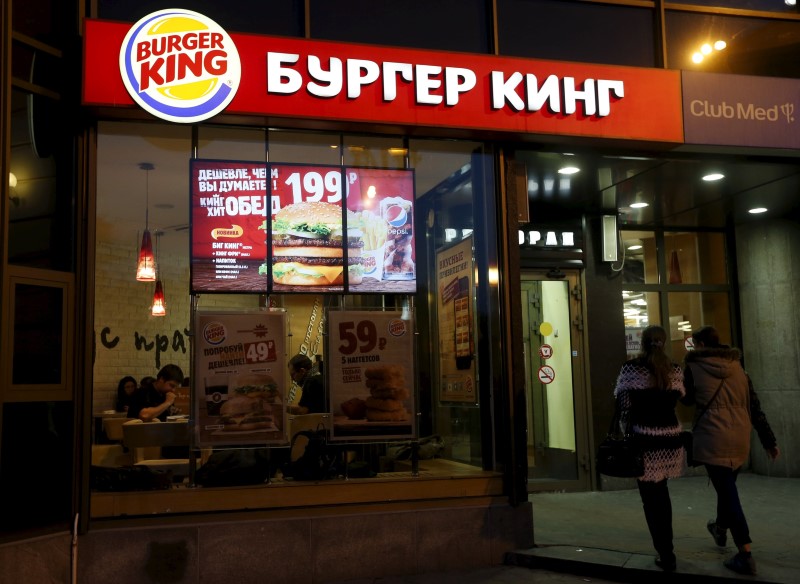 © Reuters. Women walk outside a Burger King restaurant in Moscow