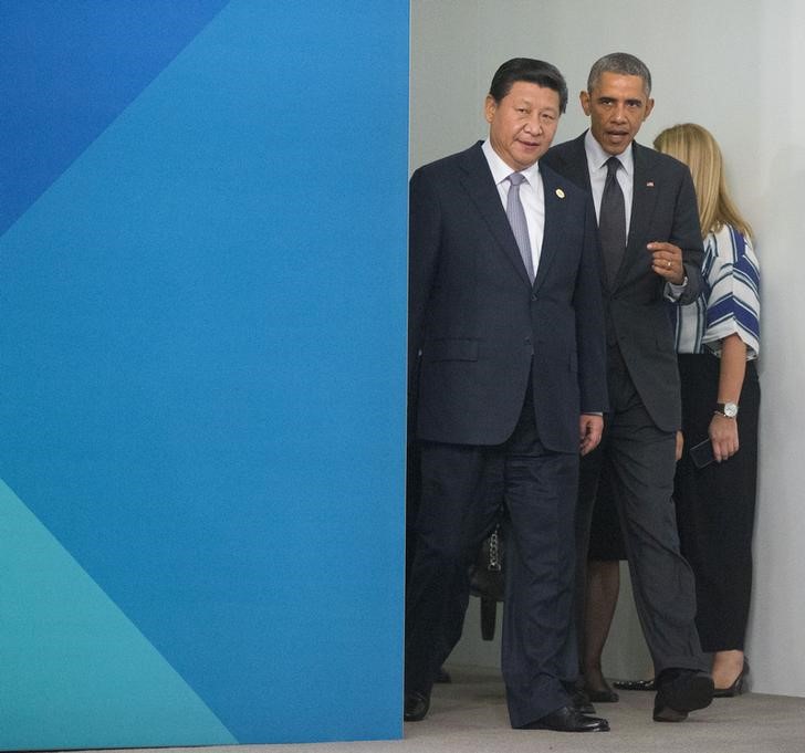 © Reuters. U.S. President Barack Obama and Chinese President Xi Jinping arrive to take a group photo at the G20 summit in Brisbane