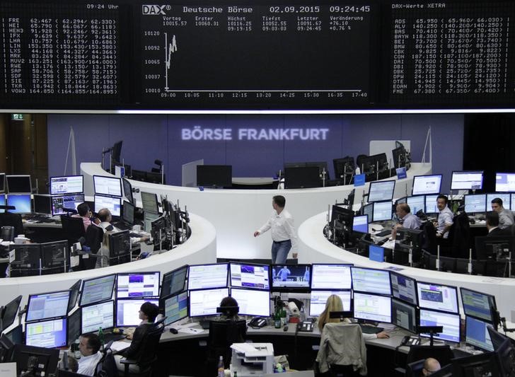 © Reuters. Traders are pictured at their desks in front of the DAX board at the Frankfurt stock exchange