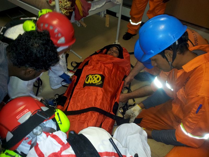 © Reuters. Handout photo of a critically ill migrant on board the CS Caprice being prepared for an emergency airlift by helicopter