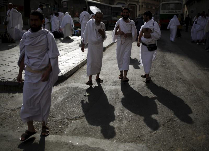 © Reuters. بالهواتف والأعلام والسلاسل البشرية الحجاج يتلمسون طريقهم في مكة