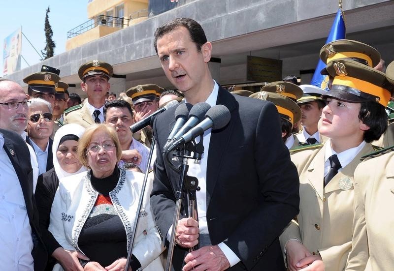 © Reuters. President Bashar al-Assad addresses his supporters at a school in an undisclosed location during an event to commemorate Syria's Martyrs' Day 