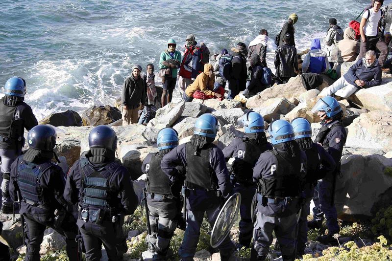 © Reuters. إيطاليا تجلي مهاجرين من مخيم على الحدود مع فرنسا